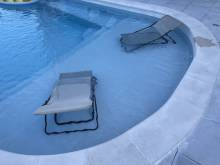 transat bain de soleil dans une piscine avec plage cocktail